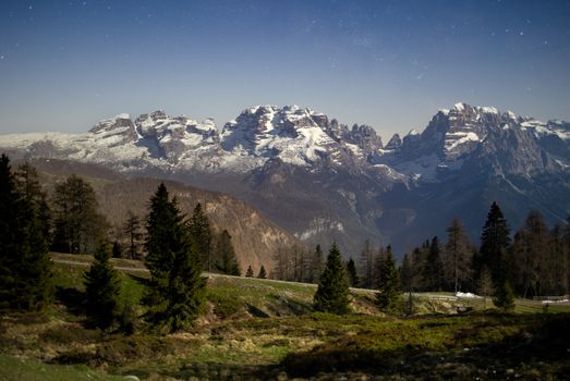Captivating night landscape of snow-capped Dolomite peaks in Madonna di Campiglio.