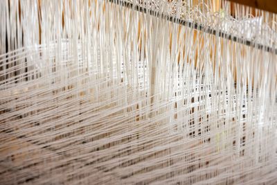 White threads stretched on a loom — photo by Magda Ehlers on Pexels