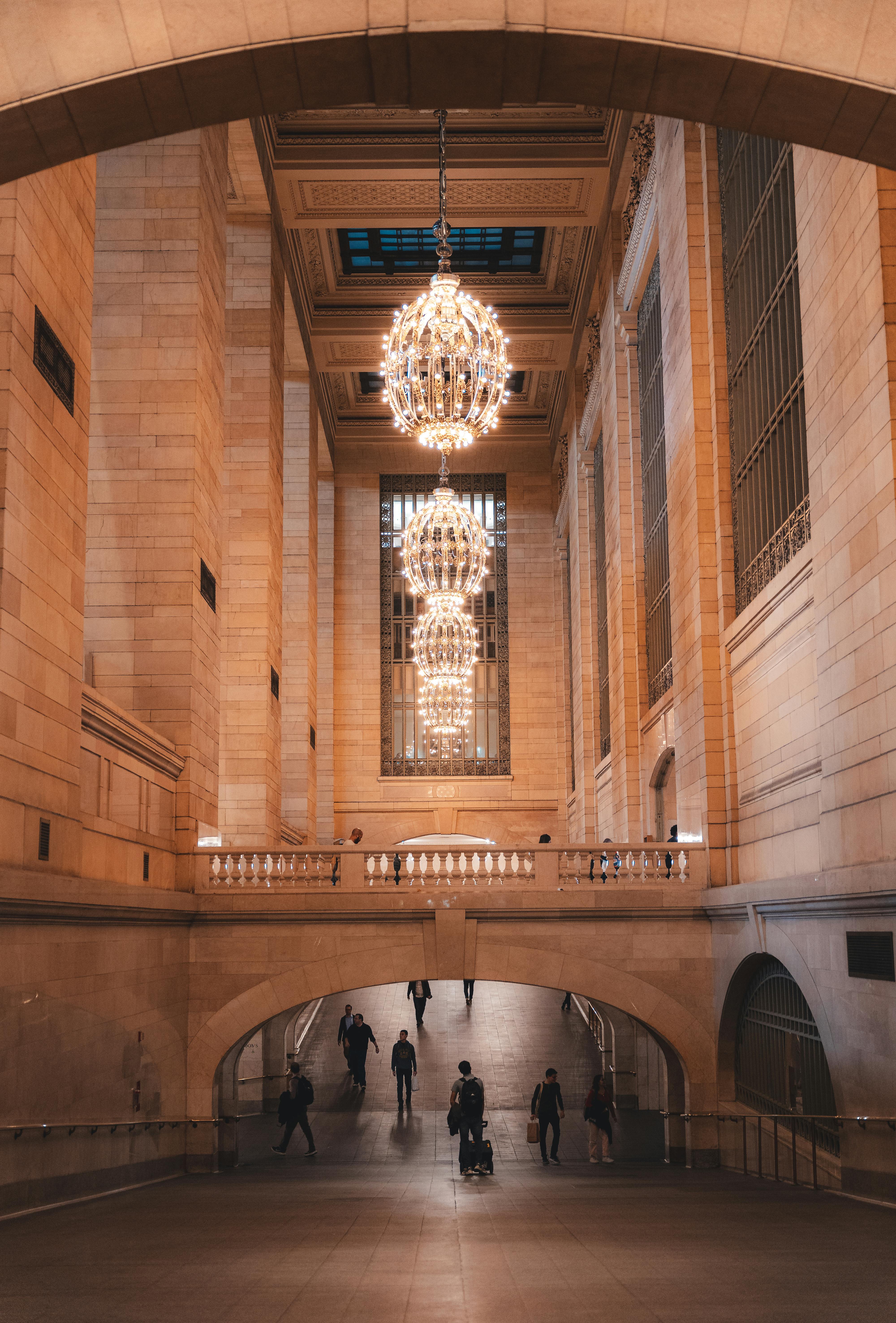 Elegant interior of Grand Central Terminal featuring chandeliers and arches.