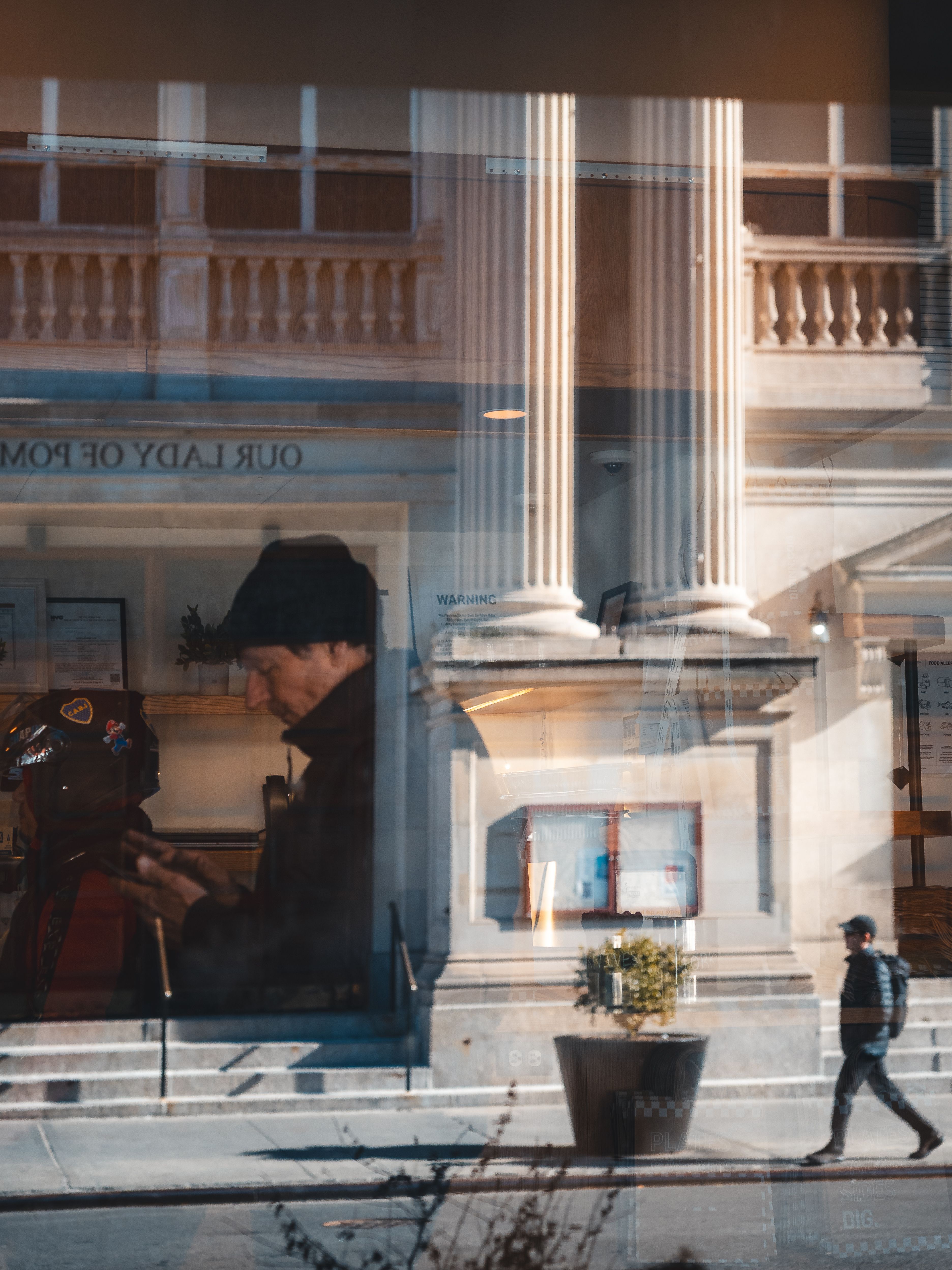 Reflective Urban Scene with Columnar Architecture · Free Stock Photo