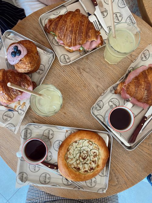 Free Top view of a brunch table with croissants, drinks, and pastries. Stock Photo