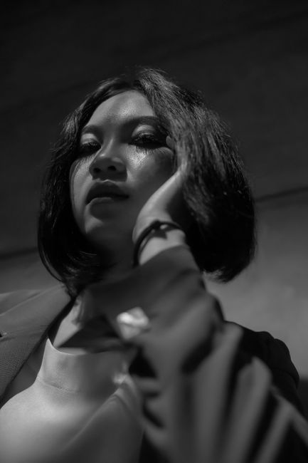 Black and white portrait of a woman in formal attire, conveying elegance.