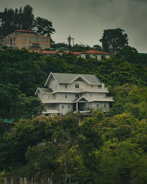 Free Aerial view of a colonial style house surrounded by lush greenery in Kohima, Nagaland, India. Stock Photo