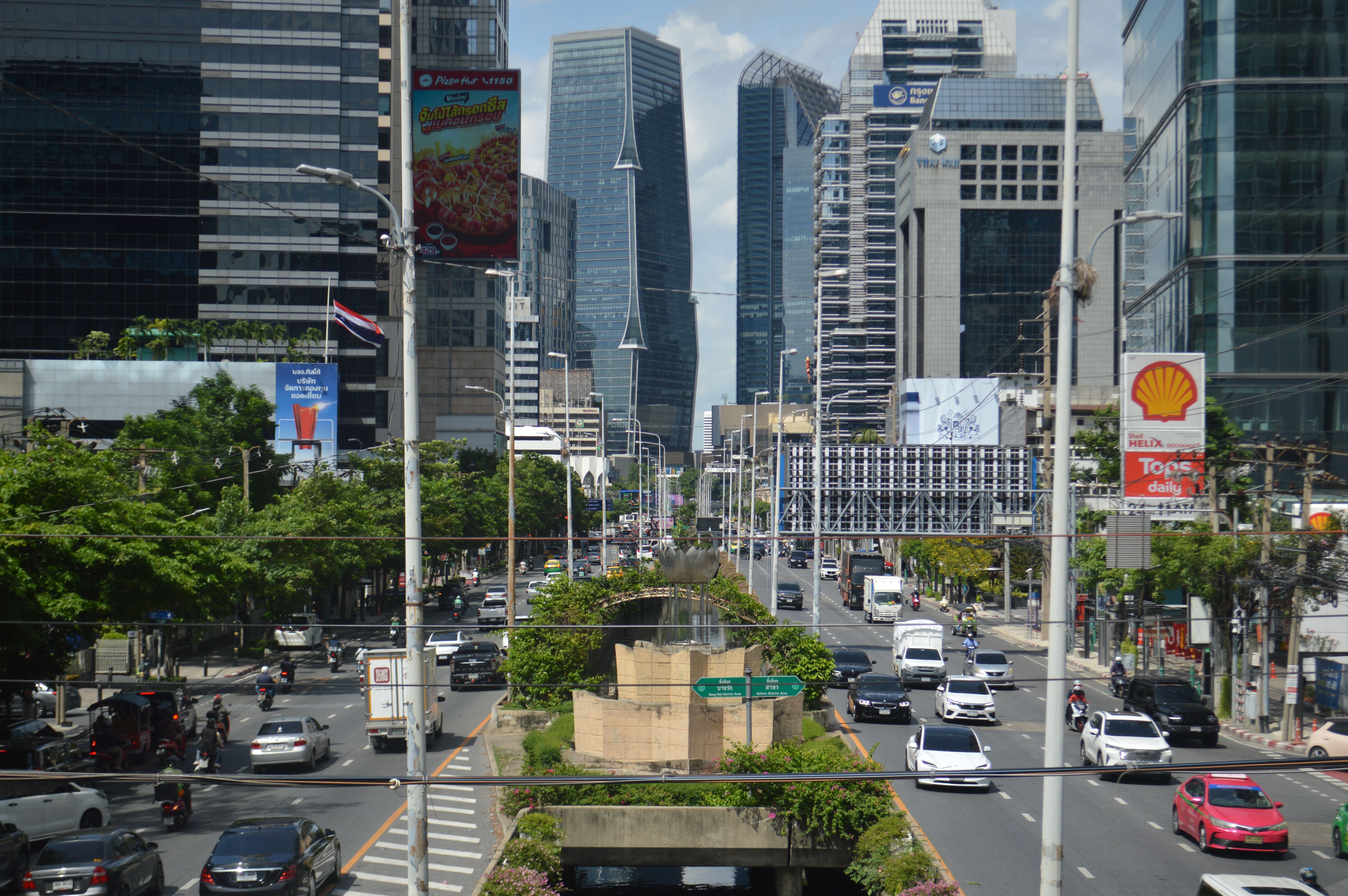 A vibrant view of a bustling business district in Thailand with modern buildings and heavy traffic