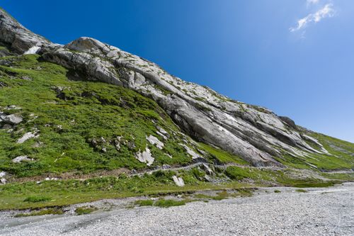 Free A stunning view of a rocky Swiss mountain slope under clear blue skies, perfect for nature enthusiasts. Stock Photo
