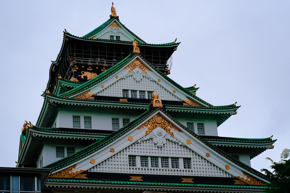 Stunning close-up of Osaka Castle's ornate architecture with golden details.