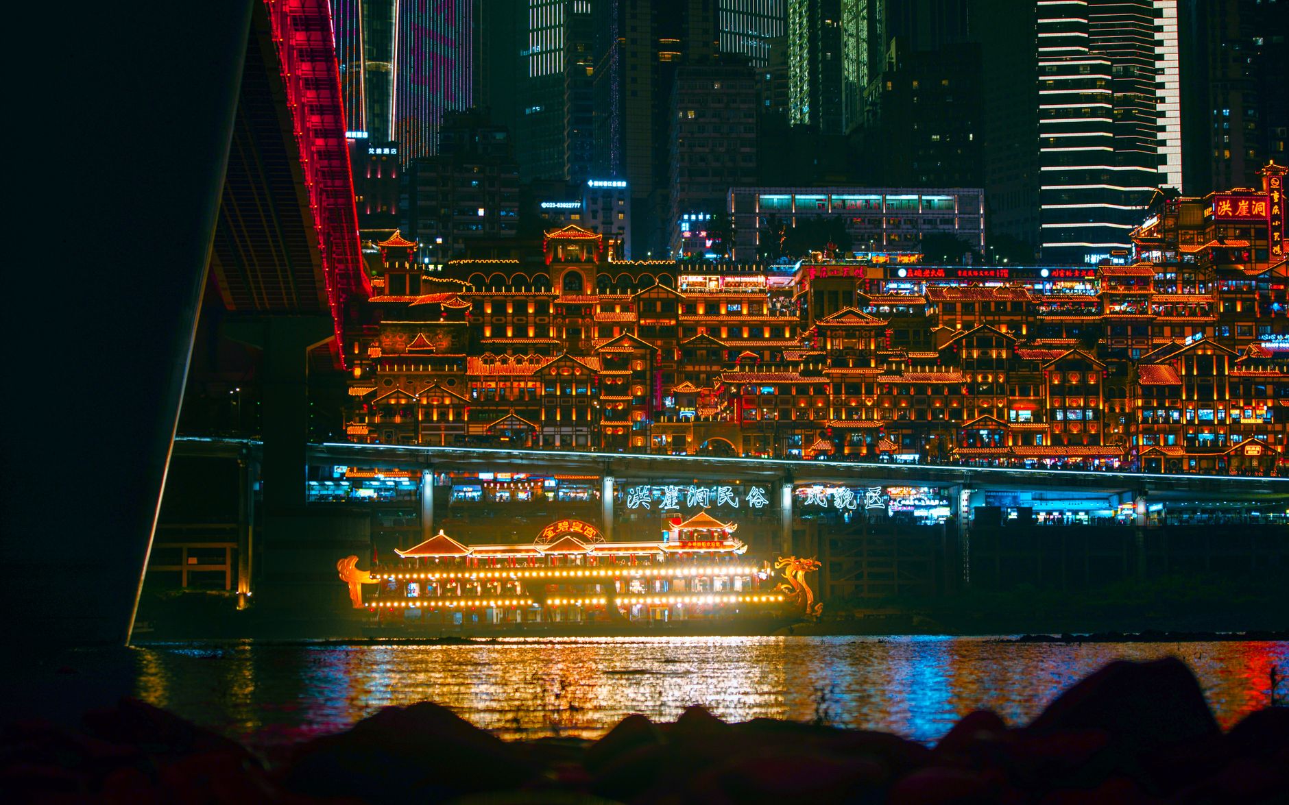 Vivid neon lights illuminate Chongqing's cityscape with reflections on the river, creating a cyberpunk atmosphere.. pexels, v
