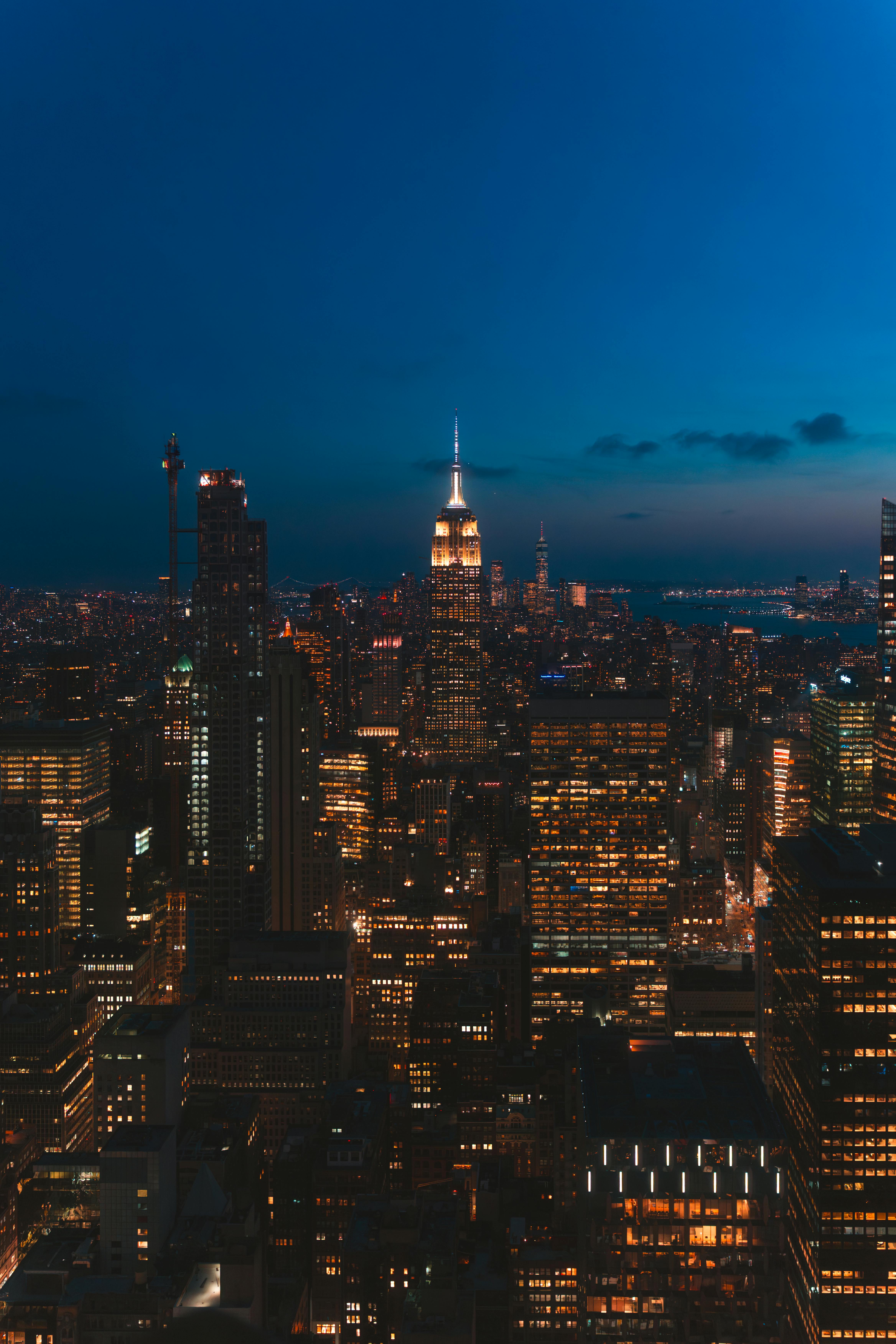 Captivating night view of New York City skyline featuring the iconic Empire State Building.