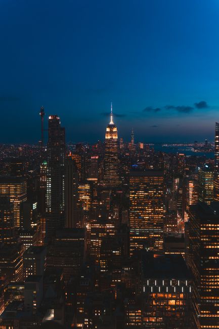 Captivating night view of New York City skyline featuring the iconic Empire State Building.