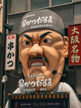 Large chef head sign outside a famous restaurant in Osaka, Japan.