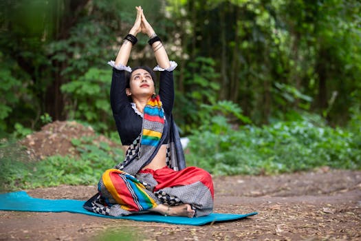South Asian woman practicing yoga outdoors, embracing wellness and mindfulness in vibrant attire.