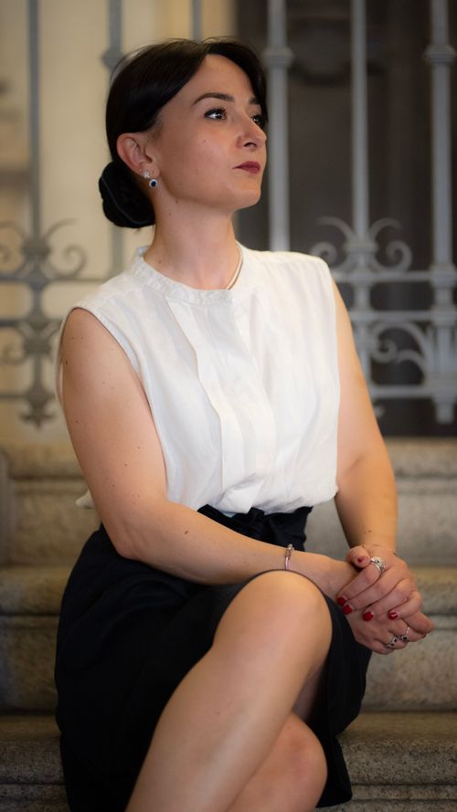 Free Elegant woman sitting on stairs, dressed in classic style, Milan, Italy. Stock Photo