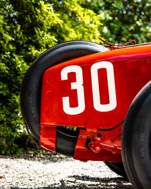 Free Close-up of a vintage race car's wheel and number 30 in bright sunlight, outdoors. Stock Photo
