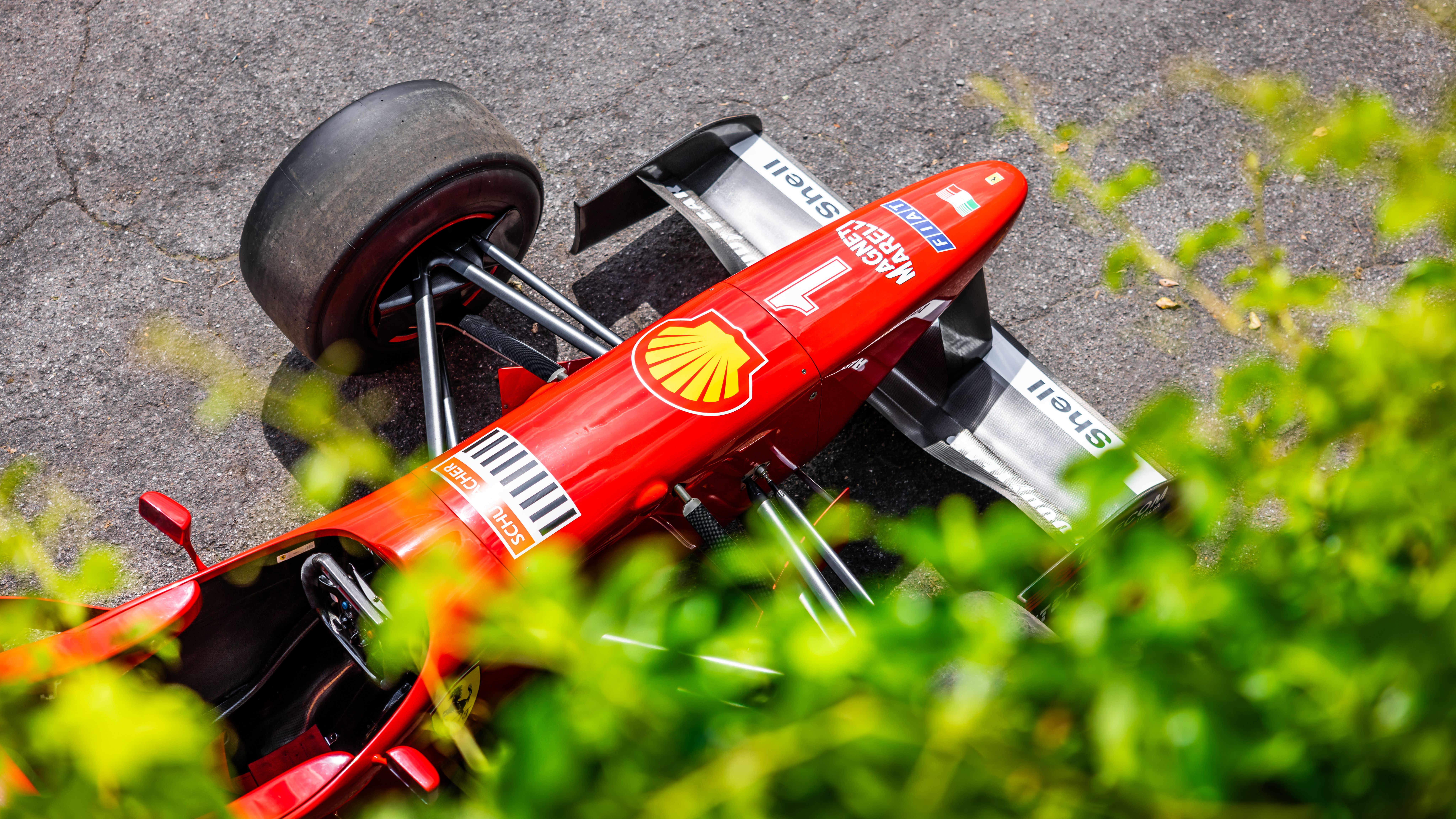 Red Formula One Car from Above in Sunlight · Free Stock Photo
