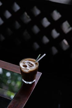Chilled iced coffee served in a glass on a rustic wooden table.