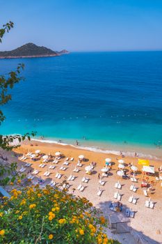 Aerial view of a pristine beach with sun loungers and turquoise waters in Antalya, Türkiye.