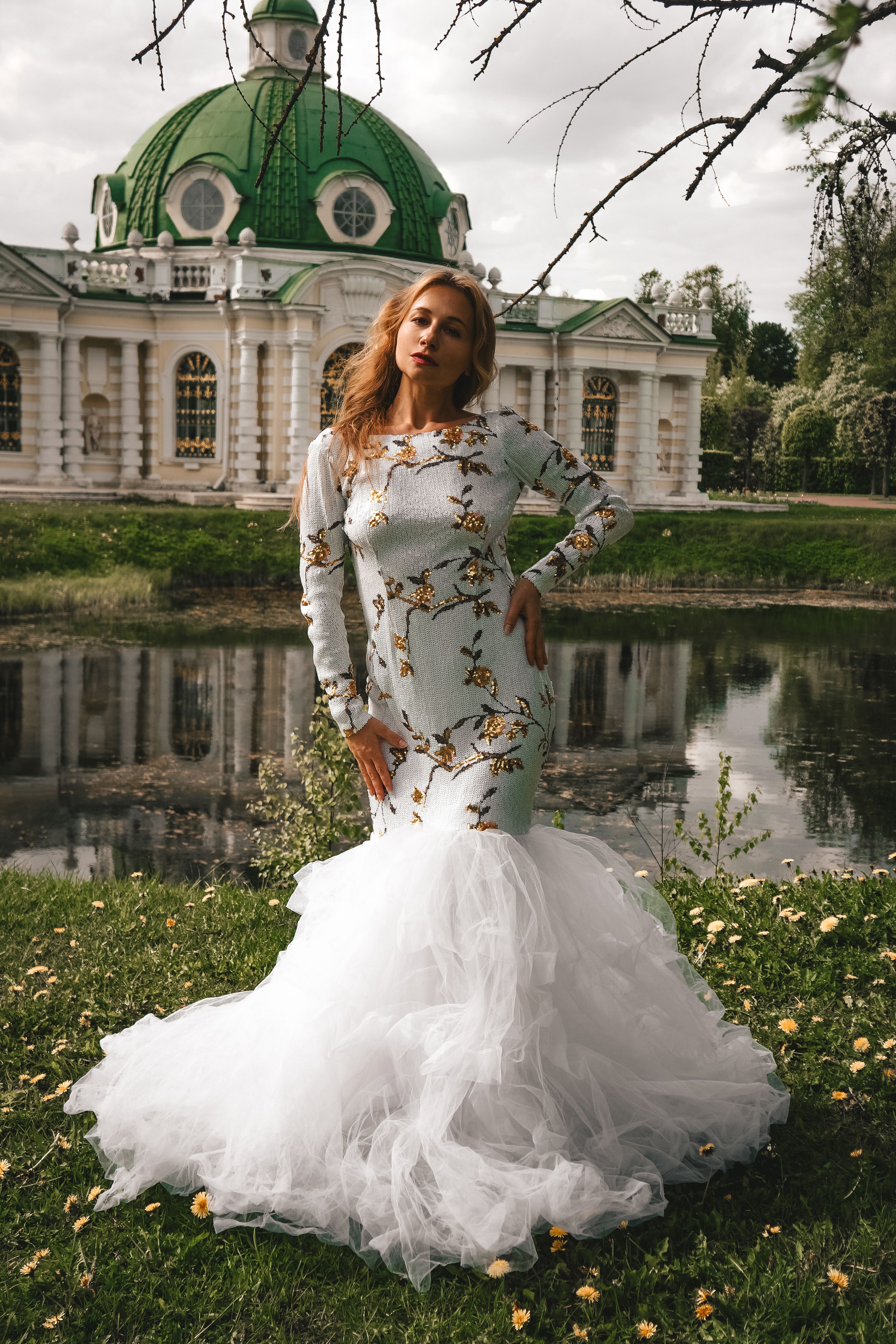 Elegant Woman in White Dress by Historic Pavilion