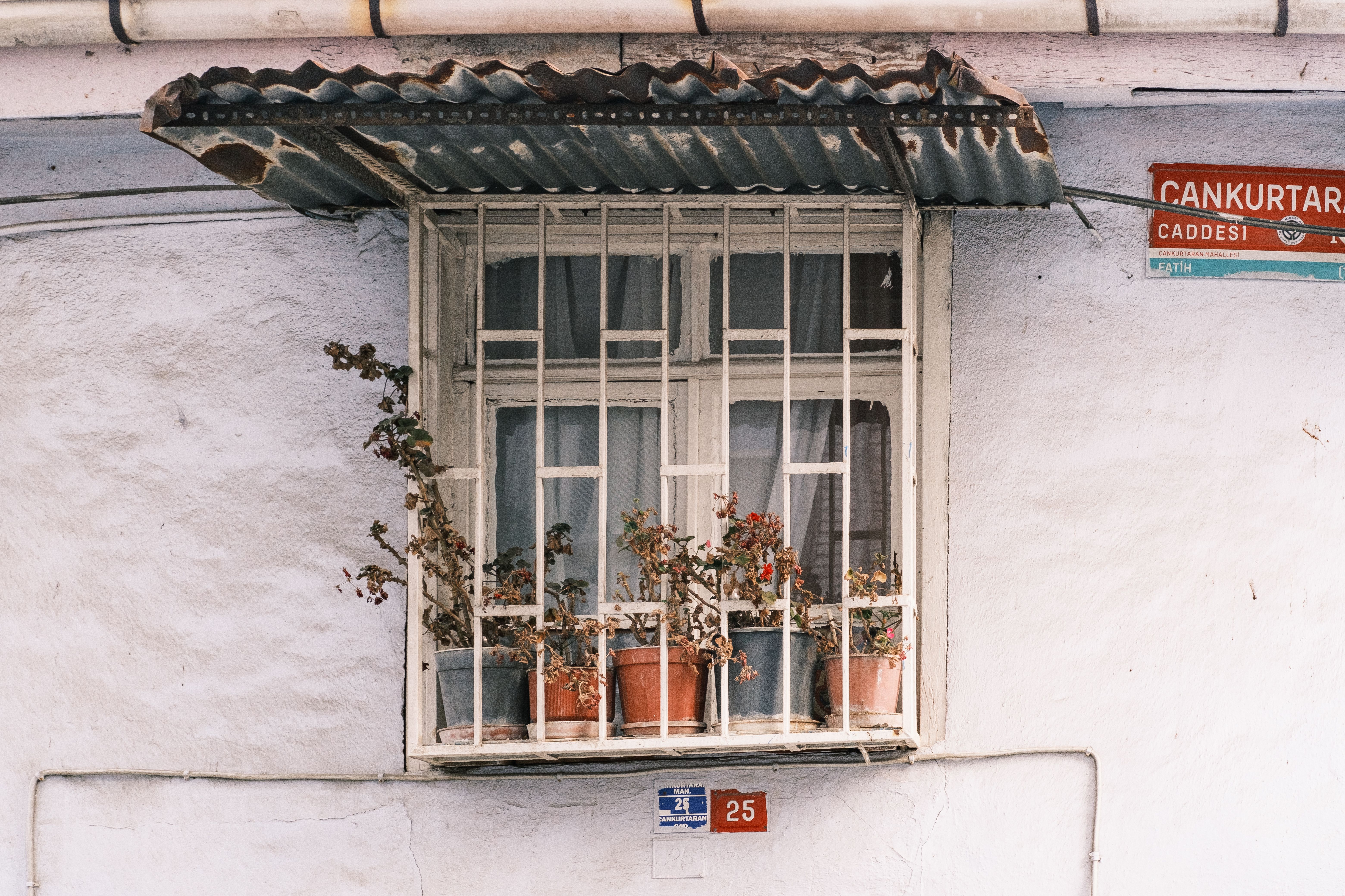 A cozy window with potted plants in İstanbul, showcasing traditional architecture.