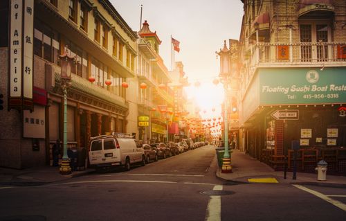 Free Chinatown street view at sunset with traditional lanterns and urban architecture. Stock Photo