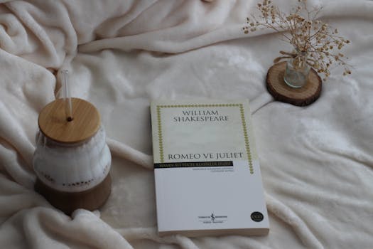 A serene indoor scene with a Romeo and Juliet book, coffee and dried flowers.