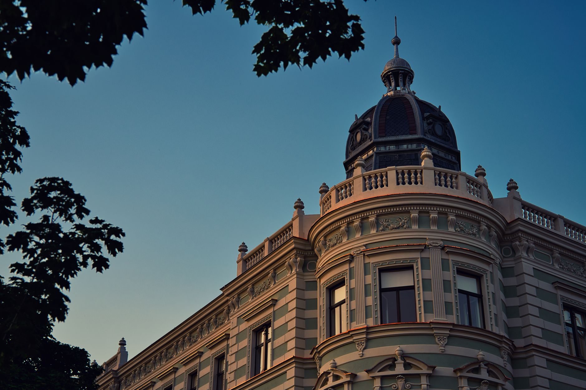 The illuminated facade of a historic university building, symbolizing the enduring legacy of elite global education.