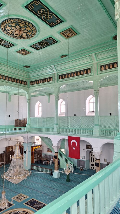 Free Elegantly designed mosque interior with chandeliers and Turkish flag. Stock Photo