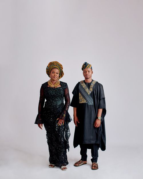Free Elegant African couple wearing traditional attire in studio setting. Stock Photo