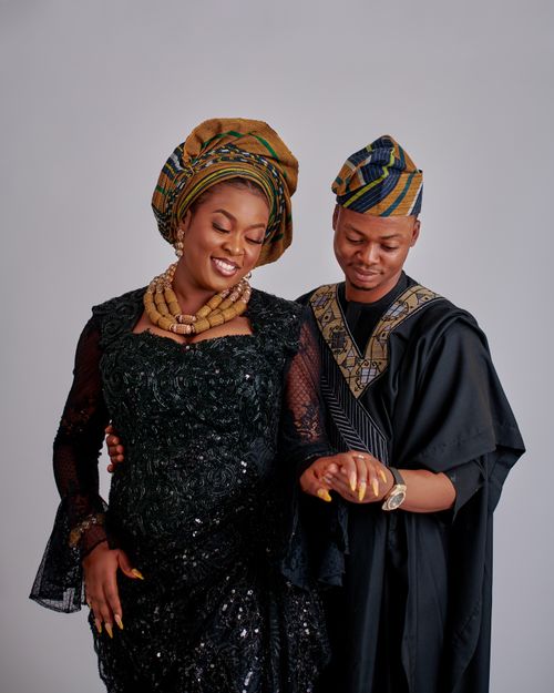 Free Portrait of a couple in Nigerian attire sharing an affectionate moment indoors. Stock Photo