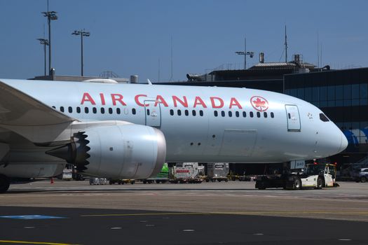 Air Canada Boeing 787 Dreamliner taxiing on Frankfurt airport runway, captured in bright daylight.