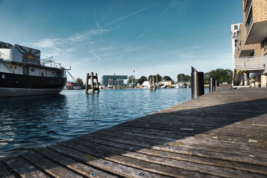 A tranquil view of a boat docked at a marina on a sunny day, perfect for travel.
