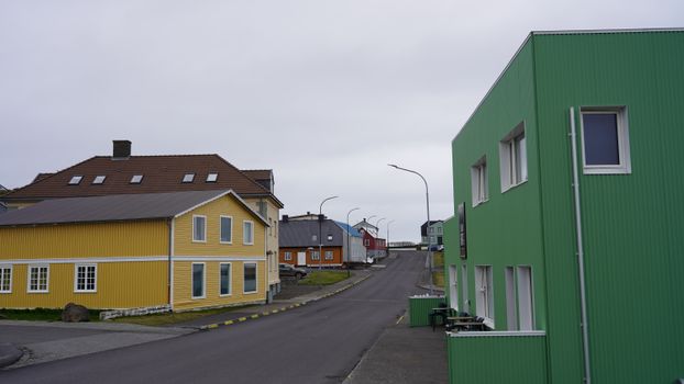 Vibrant houses line a peaceful street in Iceland, showcasing colorful architecture.