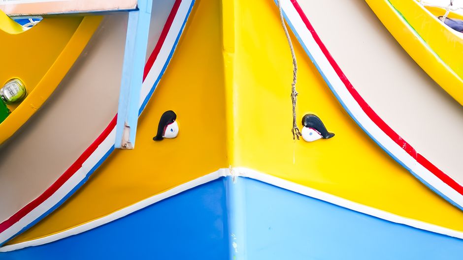 Close-up of a colorful Maltese luzzu boat featuring vibrant colors and traditional Eye of Osiris artwork.
