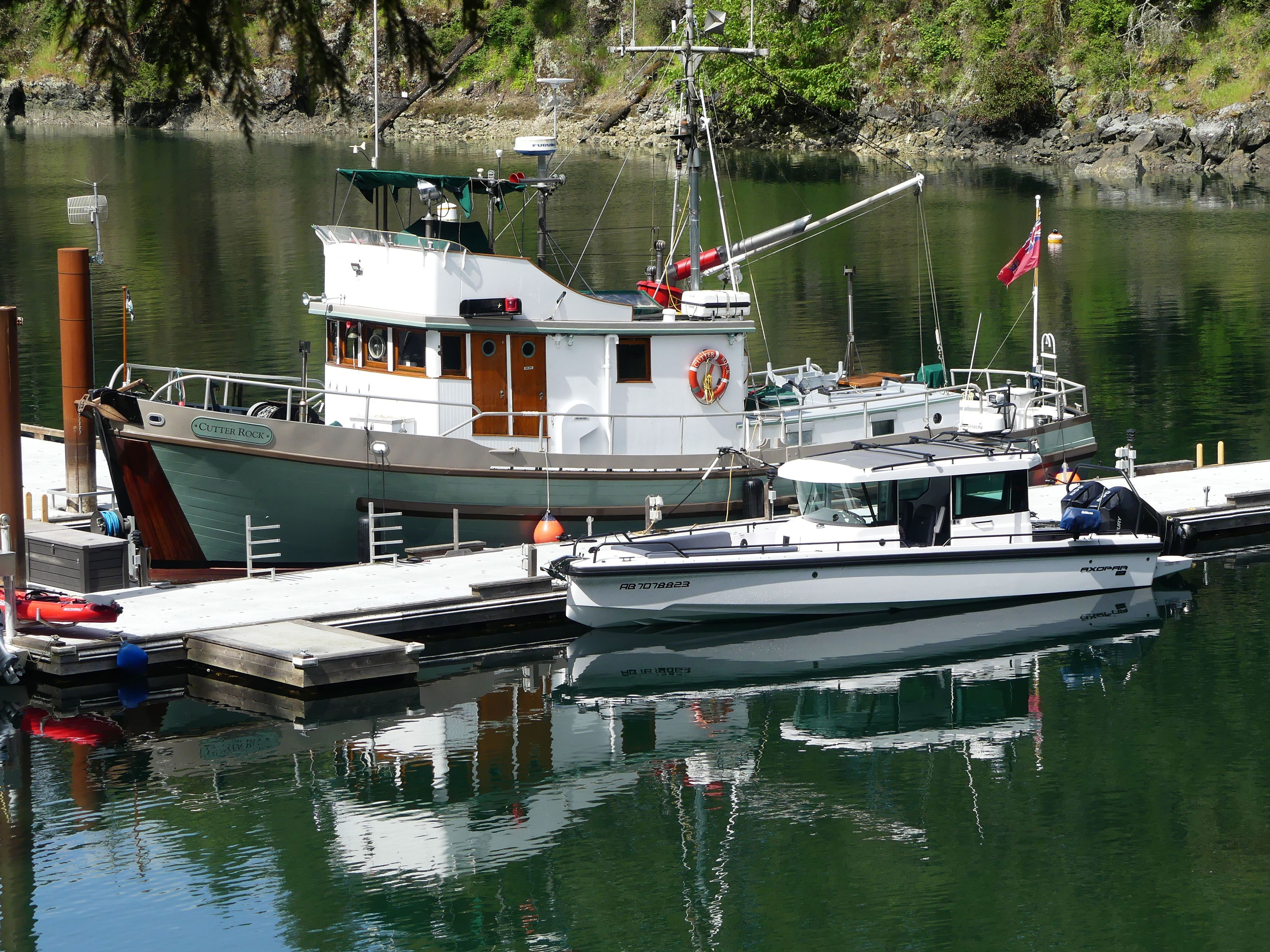 Two Boats Docked in a Scenic Harbor · Free Stock Photo