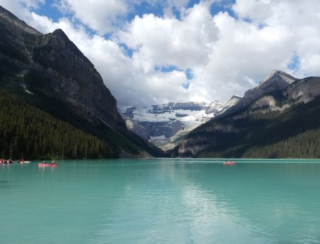 Stunning turquoise waters of Lake Louise with snow-capped mountains in Banff National Park.