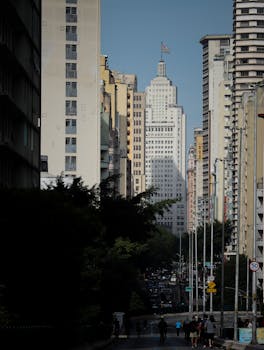 City skyline featuring skyscrapers and bustling street view under bright daylight.