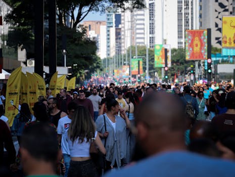 Vibrant crowd walking along Paulista Avenue in São Paulo, Brazil.