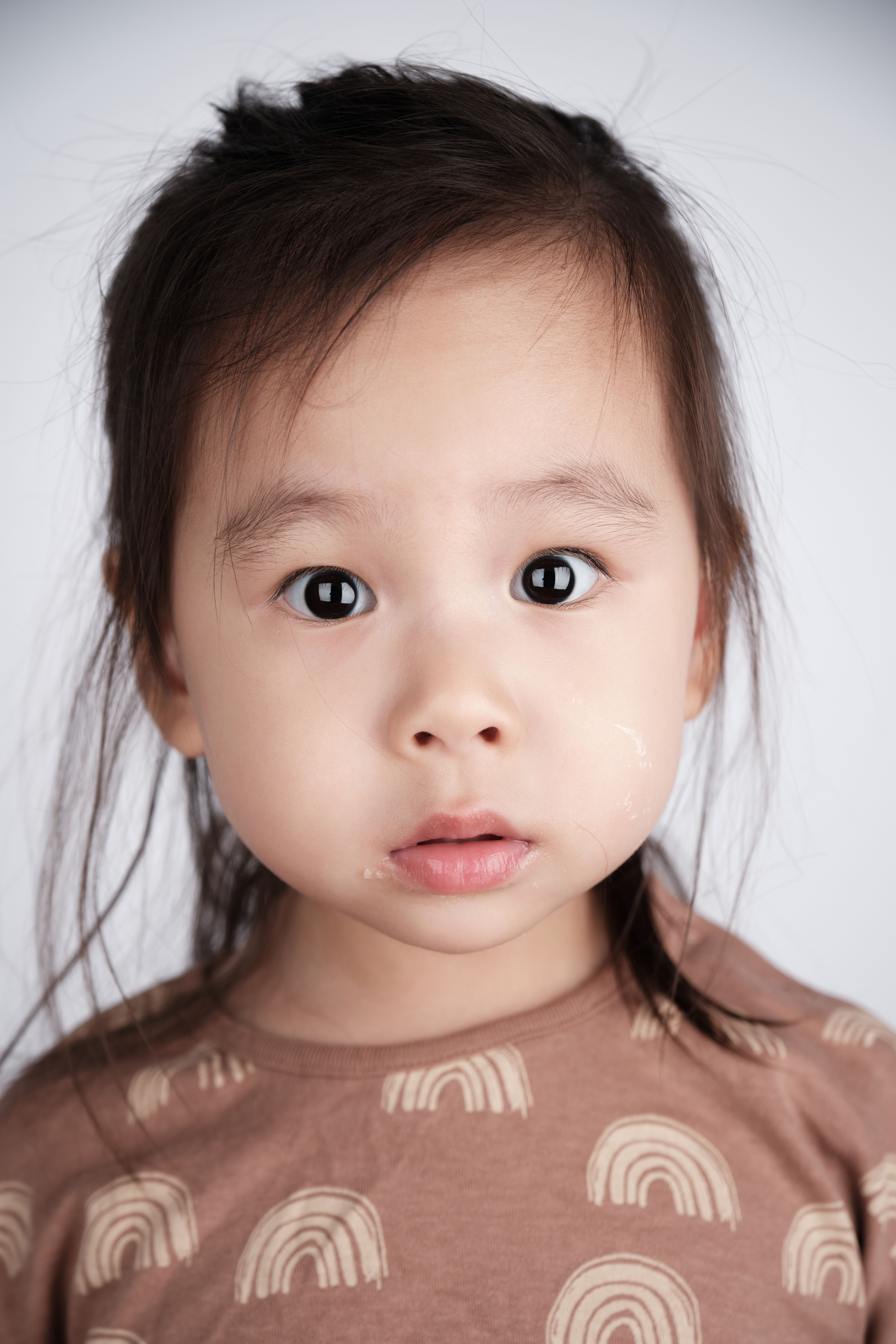 Adorable close-up portrait of a young child with innocent, wide-eyed expression.