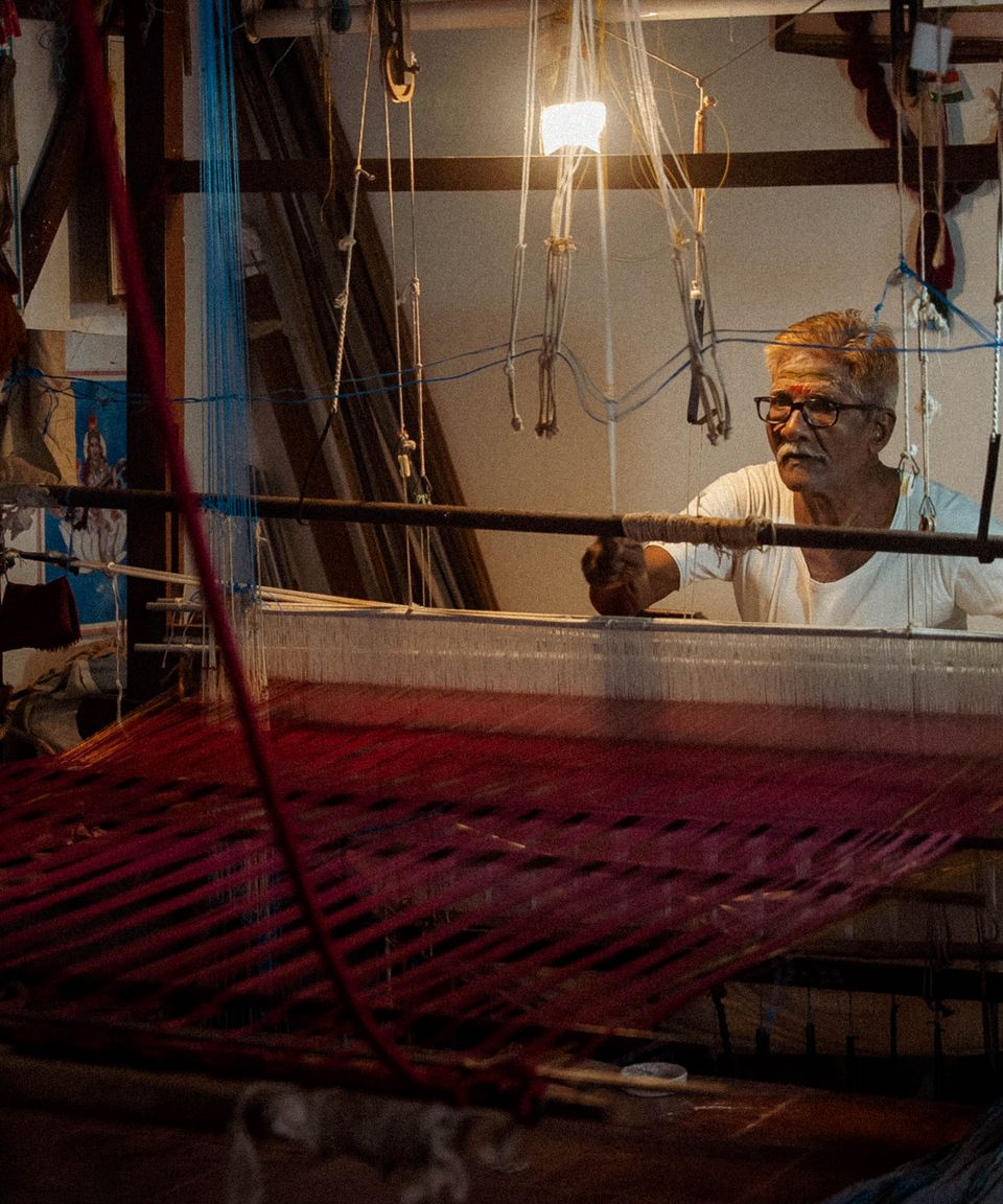 An elderly weaver at a handloom