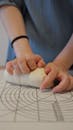 Person Kneading Fresh Dough on Baking Mat