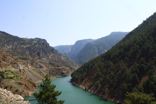 Beautiful mountain valley with green river and lush forests.