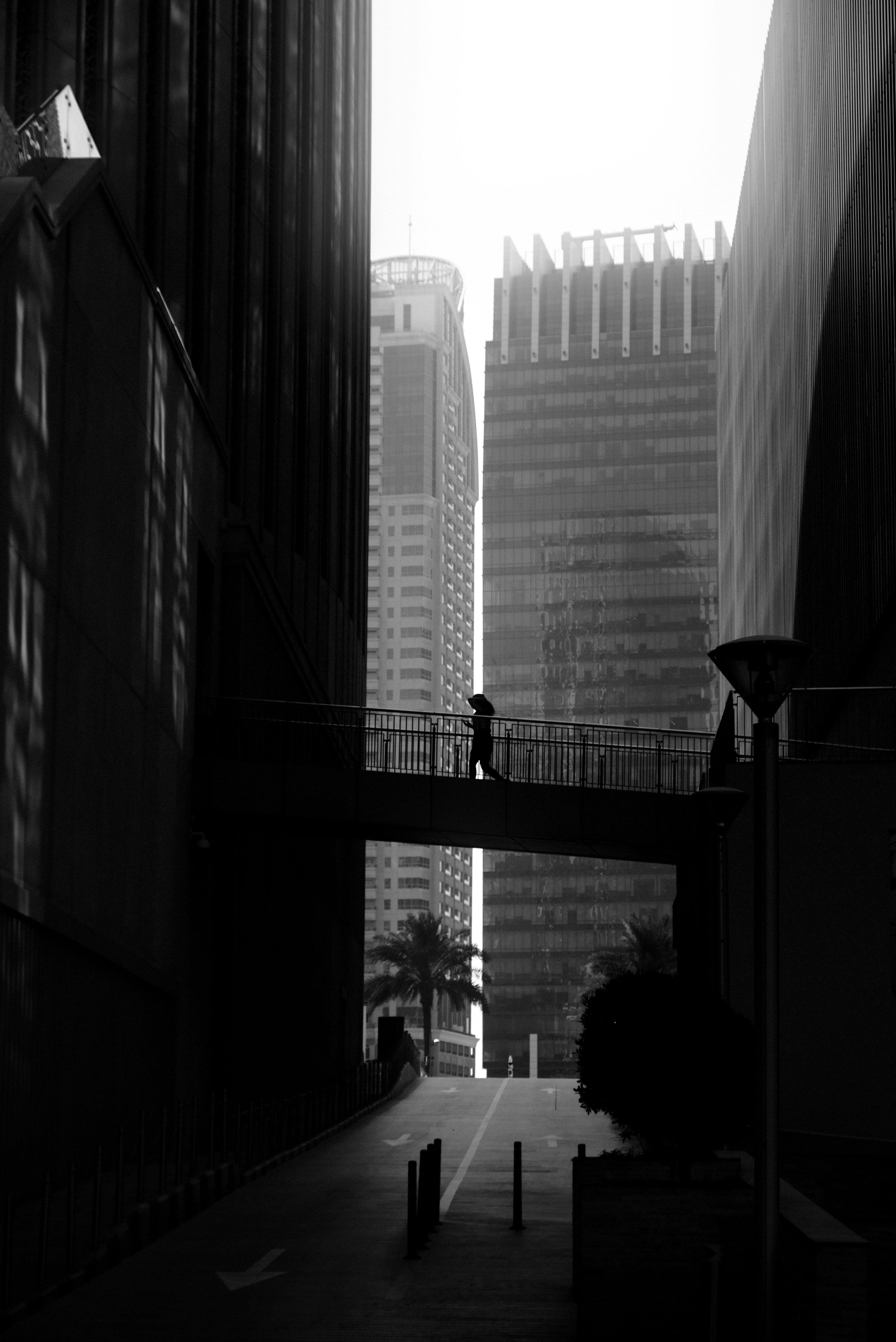 A minimalist black and white cityscape of Dubai showcasing architectural lines and a quiet urban scene.