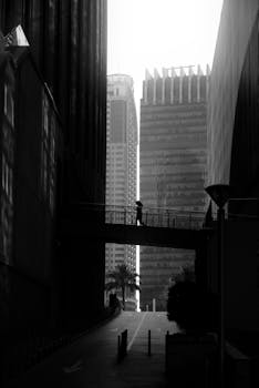 A minimalist black and white cityscape of Dubai showcasing architectural lines and a quiet urban scene.