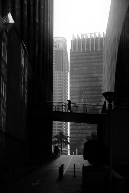 A minimalist black and white cityscape of Dubai showcasing architectural lines and a quiet urban scene.