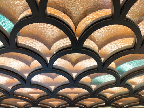 Free Artistic ceiling design with warm and cool tones creating a unique visual effect. Stock Photo