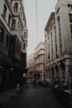 A quiet European street flanked by historic buildings and subdued lighting showcases classic architecture.