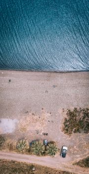 Serene aerial view of Karaburun Beach, İzmir, with coastal landscape and blue waters.