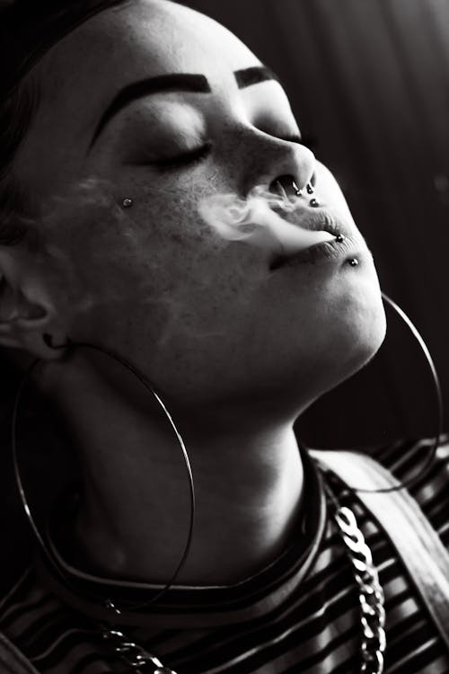 Woman Breathing Smoke