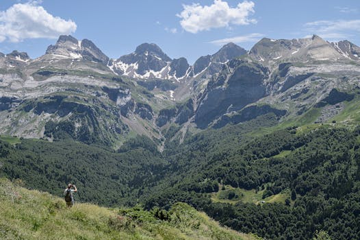 Experience the majestic beauty of the Pyrenees with a lone hiker embracing nature.