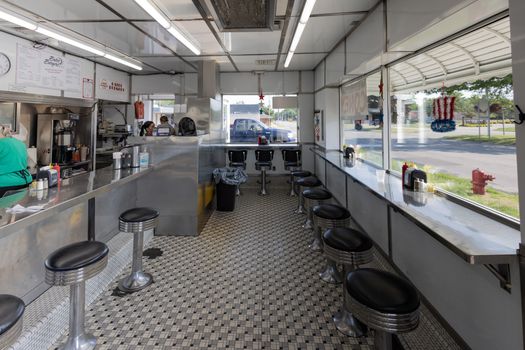 Retro diner interior with checkered floor and stool seating in Livonia, Michigan.
