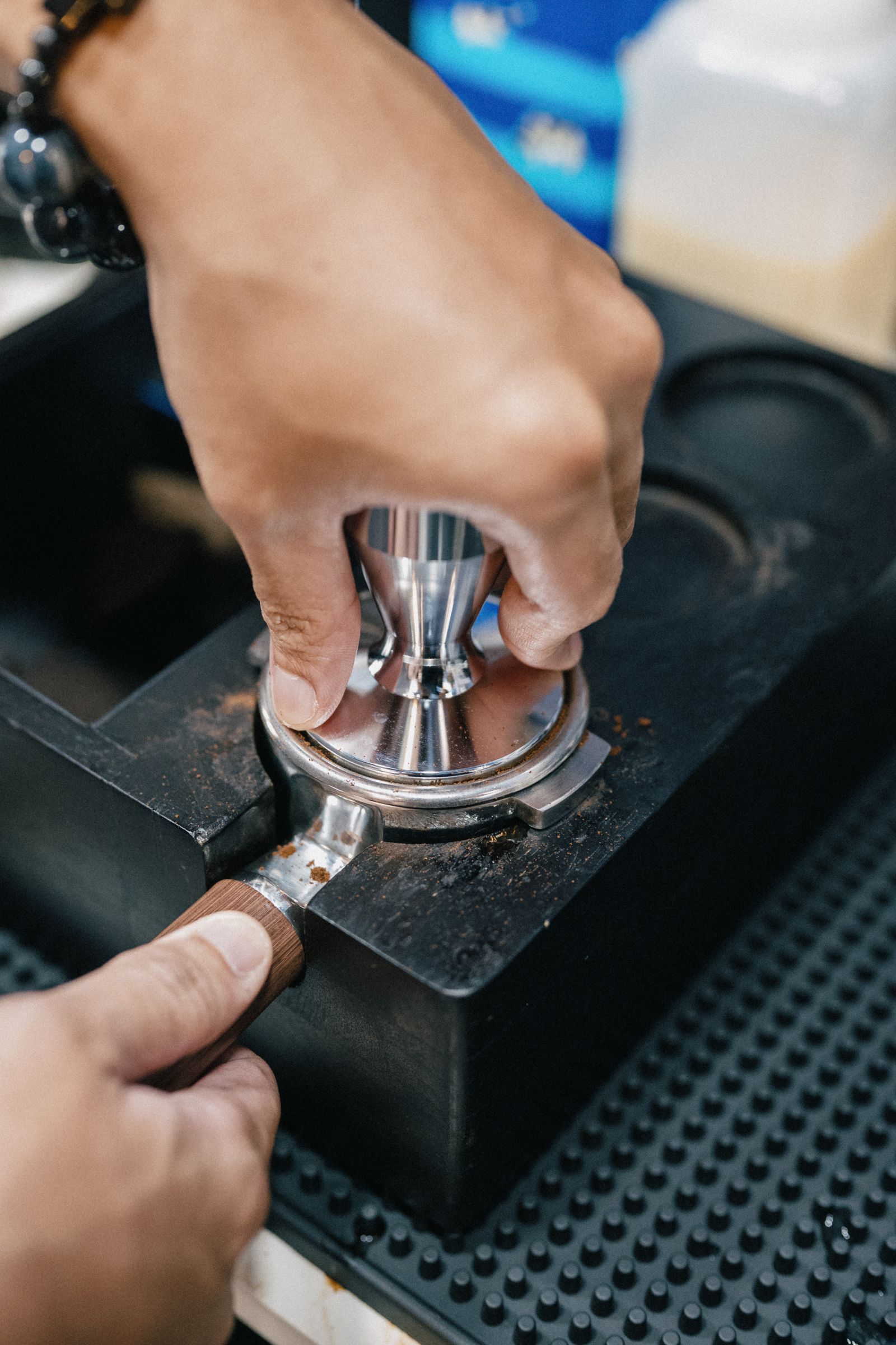 Barista using a tamper during espresso puck preparation